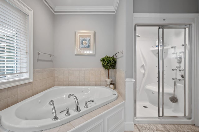 bathroom featuring ornamental molding and separate shower and tub