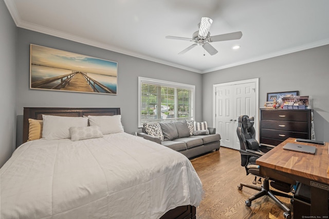 bedroom featuring crown molding, a closet, and light wood-type flooring