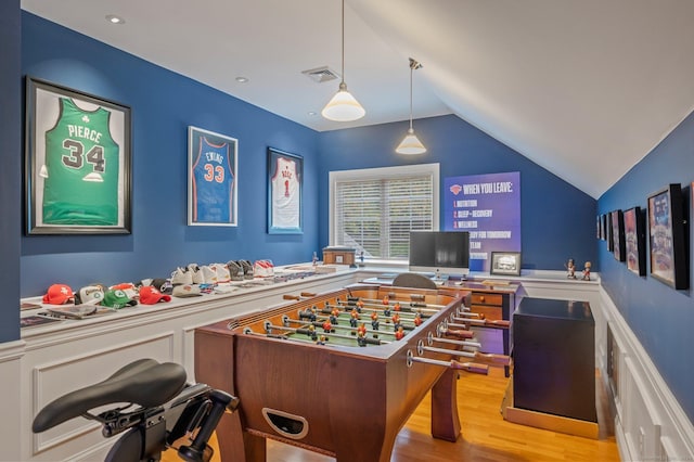 recreation room with lofted ceiling and light wood-type flooring