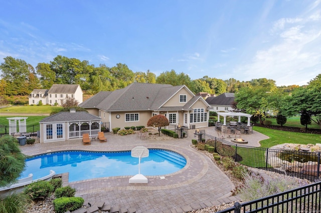 view of pool featuring a bar, an outdoor structure, a pergola, and a patio