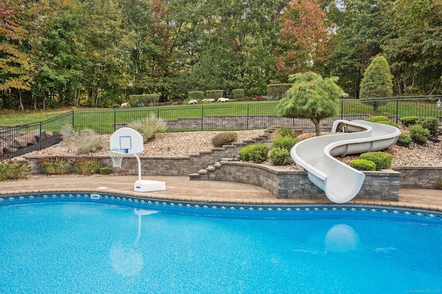 view of swimming pool featuring a water slide