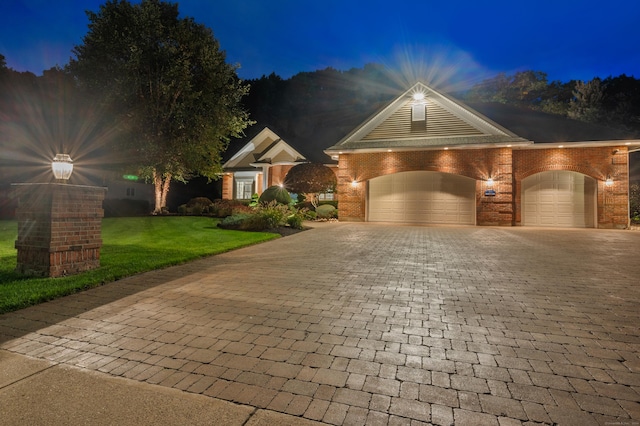 view of front of house with a garage and a lawn