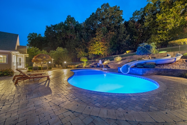 view of pool featuring a water slide and a patio area