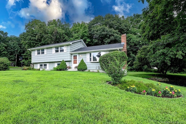 tri-level home with a front yard