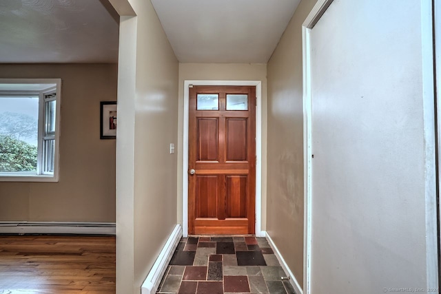 doorway to outside featuring baseboard heating