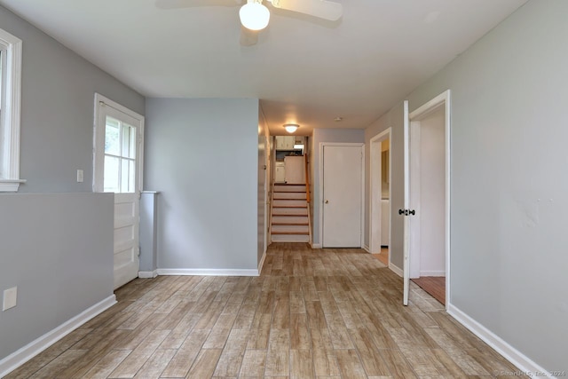 spare room featuring light wood-type flooring and ceiling fan