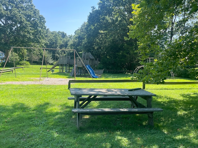 view of community featuring a playground and a yard