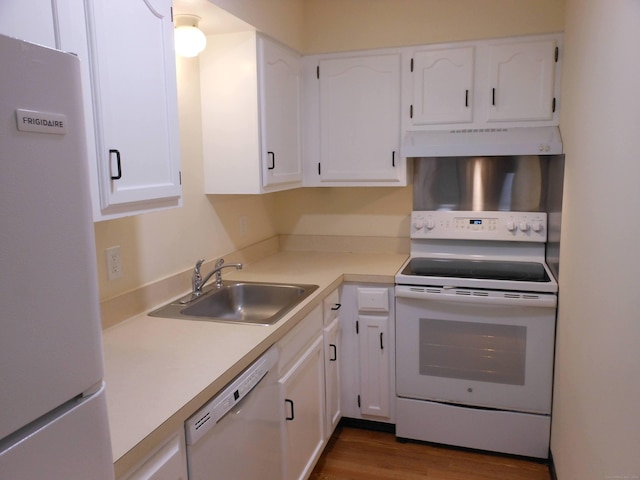 kitchen with sink, dark wood-type flooring, white cabinets, and white appliances