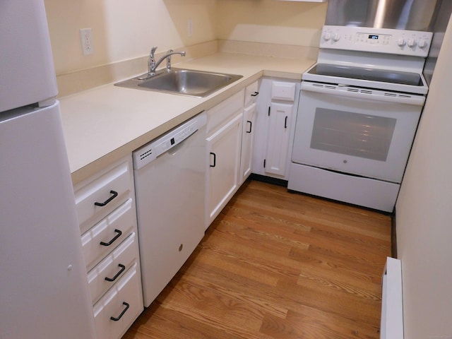 kitchen with white cabinetry, white appliances, sink, and light hardwood / wood-style flooring