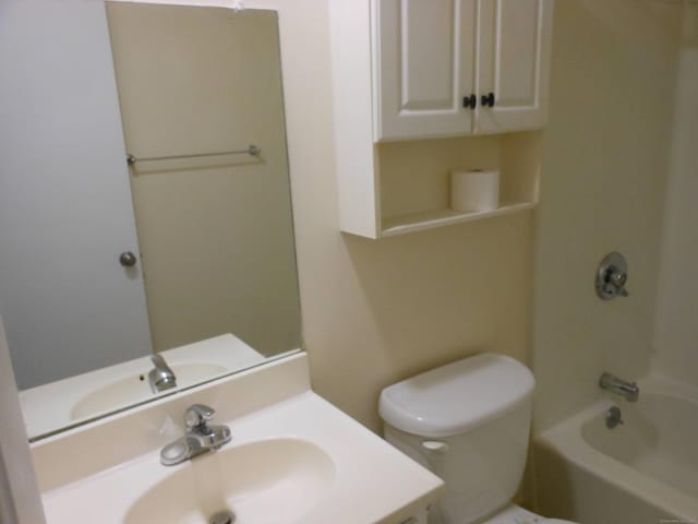 full bathroom featuring shower / bath combination, vanity, and toilet