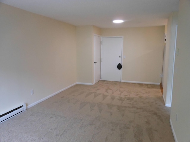 unfurnished room with light colored carpet and baseboard heating