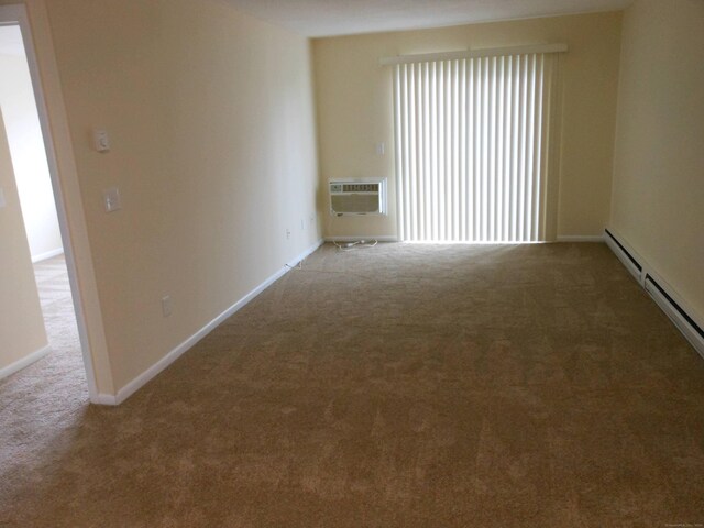 carpeted spare room featuring baseboard heating and a wall mounted AC