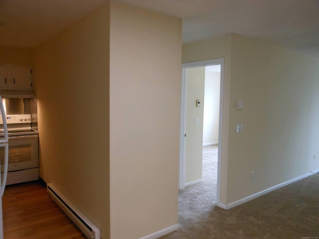 corridor with carpet floors and a baseboard radiator