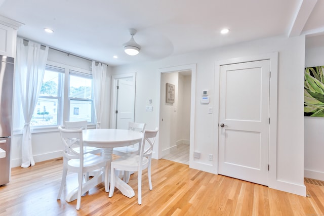 dining area with ceiling fan and light wood-type flooring