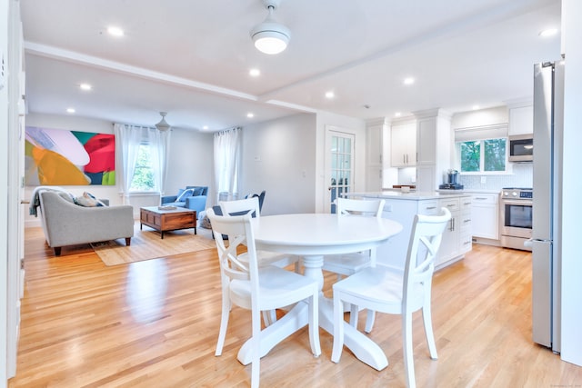 dining area with light hardwood / wood-style flooring and plenty of natural light