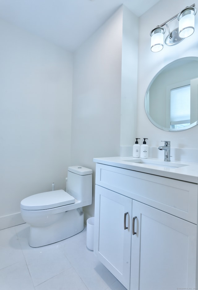 bathroom featuring vanity, toilet, and tile patterned floors