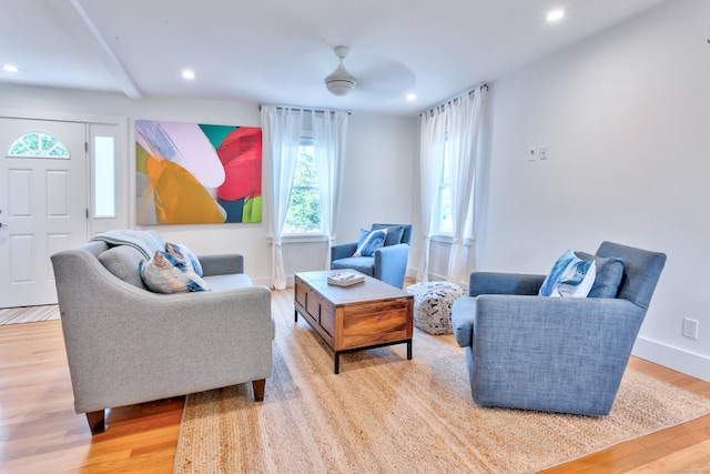 living room with light hardwood / wood-style flooring and ceiling fan