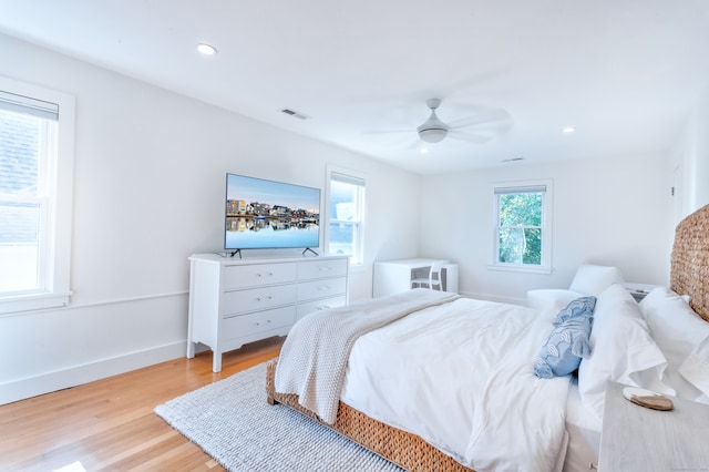 bedroom with light hardwood / wood-style flooring and ceiling fan