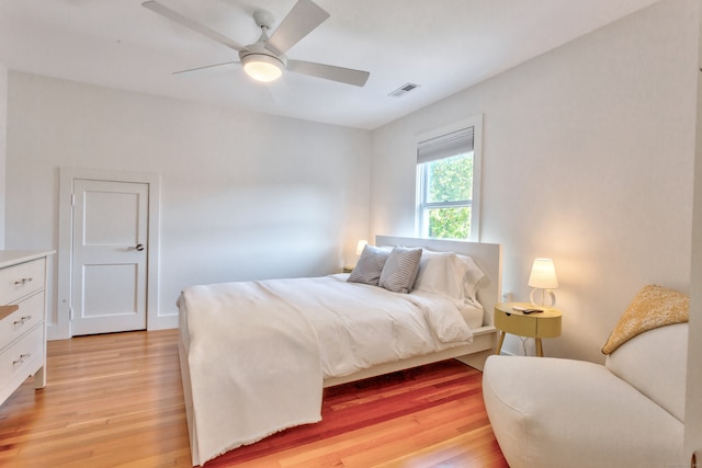 bedroom with ceiling fan and light hardwood / wood-style floors