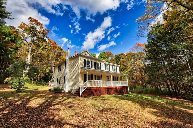 view of front of house featuring a front yard and covered porch