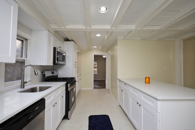 kitchen featuring white cabinets, appliances with stainless steel finishes, and sink