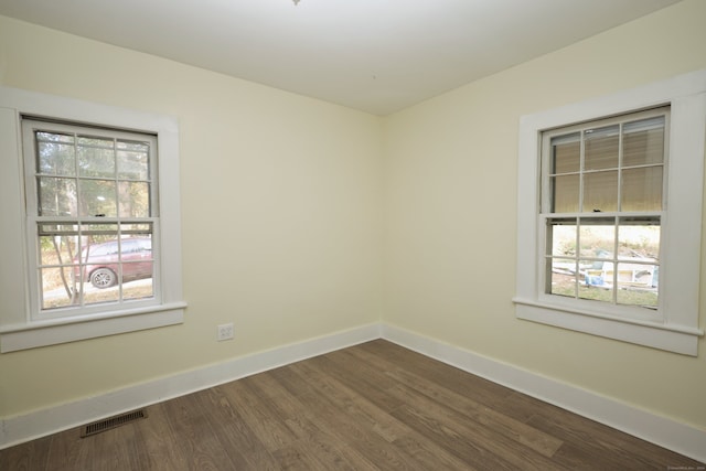 unfurnished room with hardwood / wood-style floors