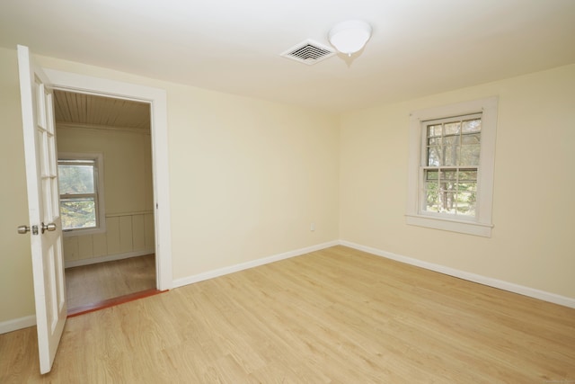 spare room featuring light hardwood / wood-style floors and a wealth of natural light