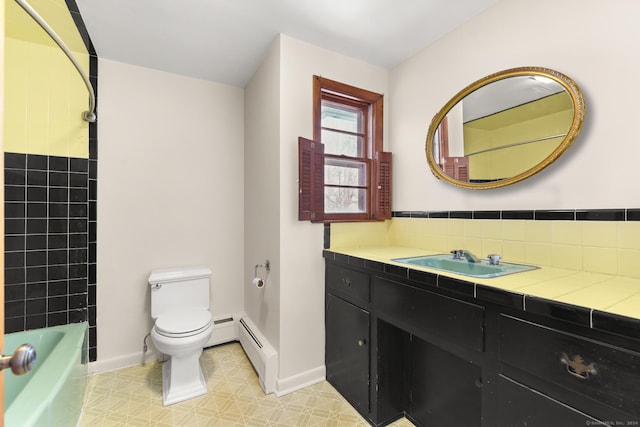 full bathroom featuring toilet, vanity, tiled shower / bath combo, and a baseboard radiator