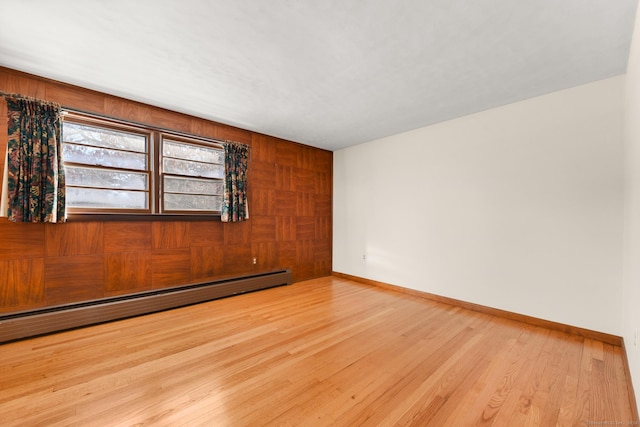 spare room with light hardwood / wood-style floors and a baseboard radiator