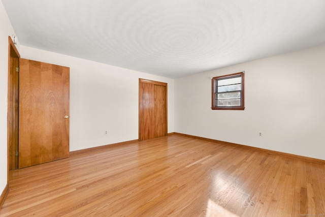 spare room featuring light hardwood / wood-style flooring