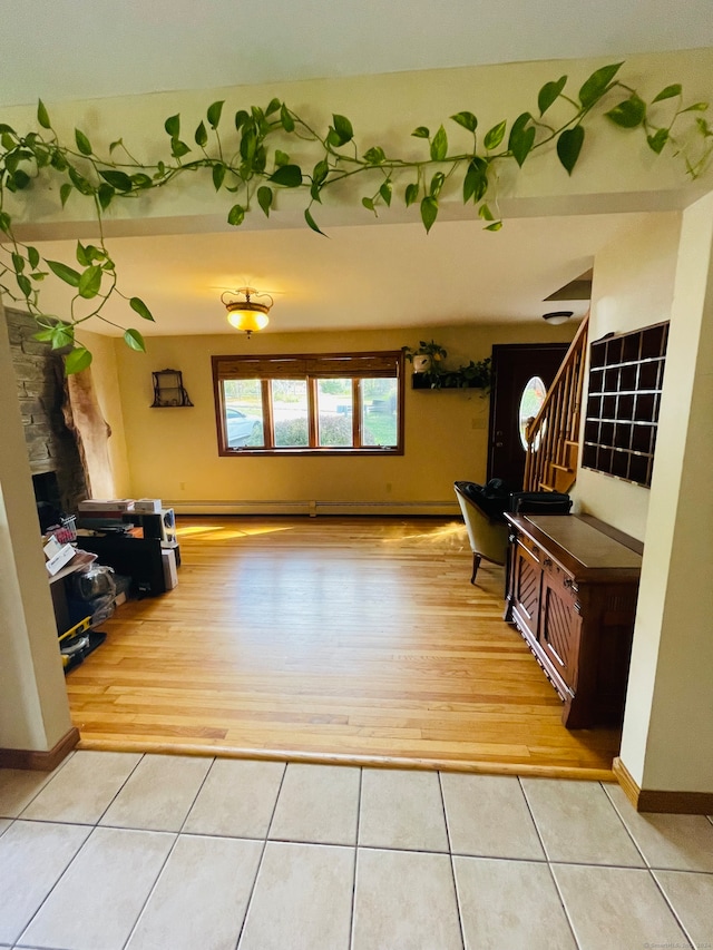 interior space with a stone fireplace and hardwood / wood-style floors