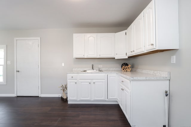 kitchen featuring white cabinetry, dark hardwood / wood-style floors, and sink