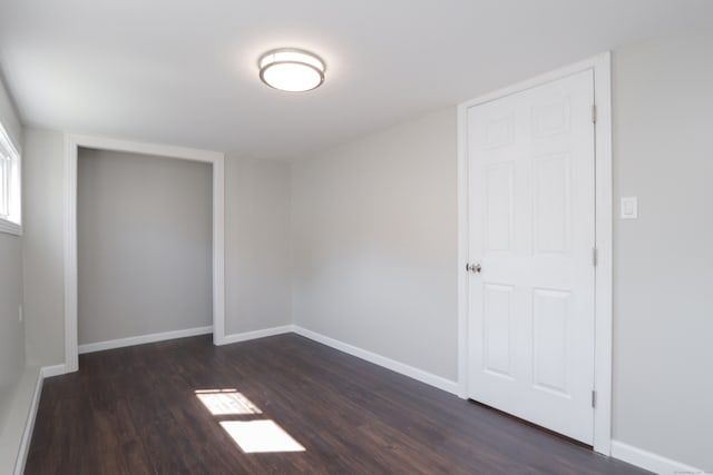 empty room featuring dark wood-type flooring