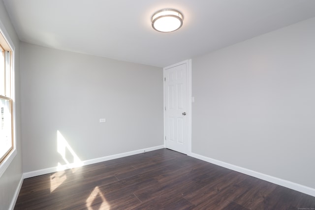 empty room featuring dark hardwood / wood-style floors and a healthy amount of sunlight