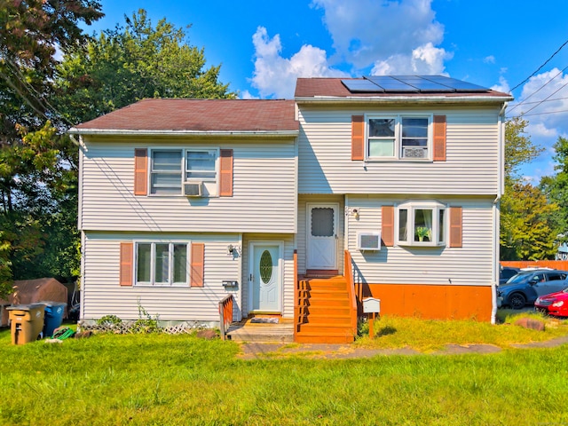 view of front facade featuring cooling unit and a front lawn