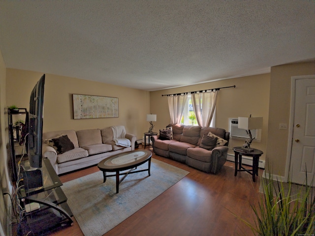 living room with a textured ceiling, dark hardwood / wood-style floors, a wall mounted air conditioner, and a baseboard heating unit