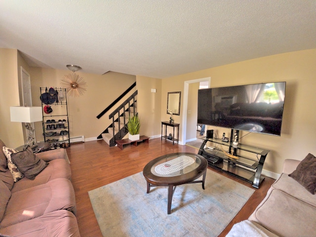 living room with a textured ceiling, a baseboard radiator, and hardwood / wood-style flooring