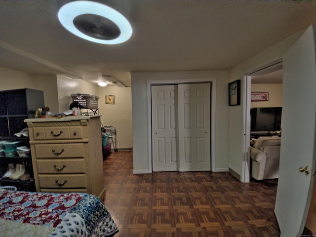 bedroom featuring a closet and dark parquet floors