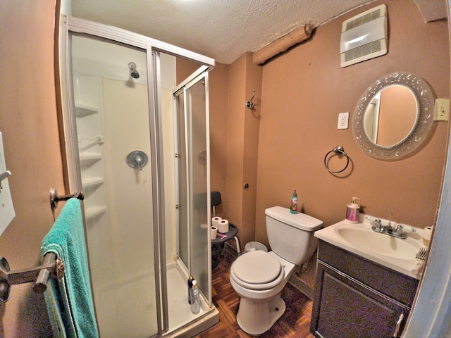 bathroom with vanity, an enclosed shower, a textured ceiling, parquet flooring, and toilet