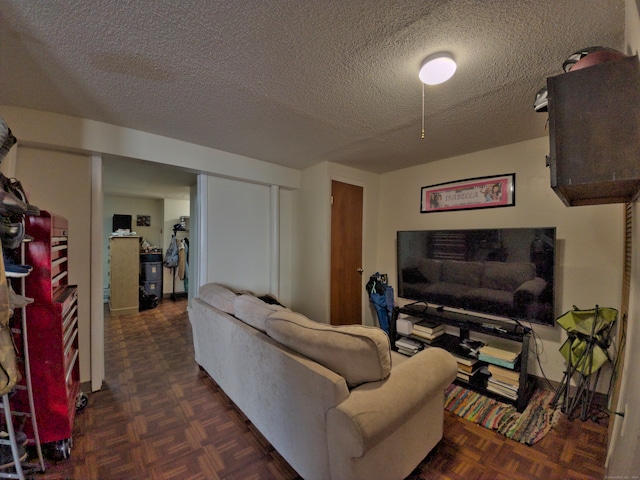 living room featuring a textured ceiling and dark parquet flooring