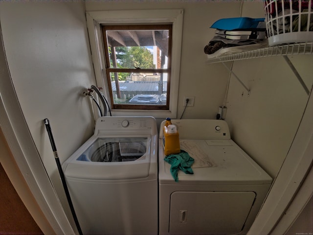 clothes washing area featuring independent washer and dryer