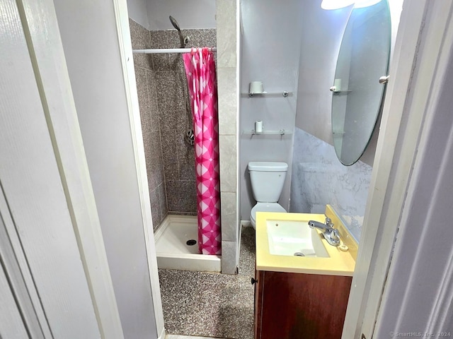 bathroom featuring walk in shower, vanity, and toilet