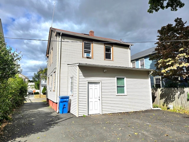 back of house featuring cooling unit