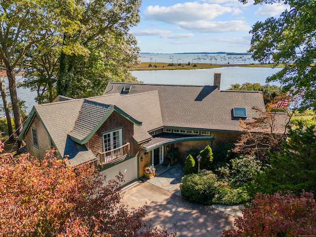 view of front of property with a water view and a garage