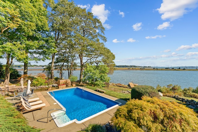 view of swimming pool featuring a water view and a patio area