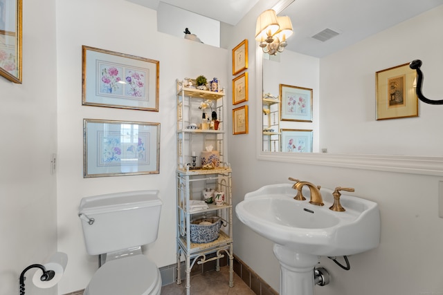 bathroom with toilet and tile patterned floors