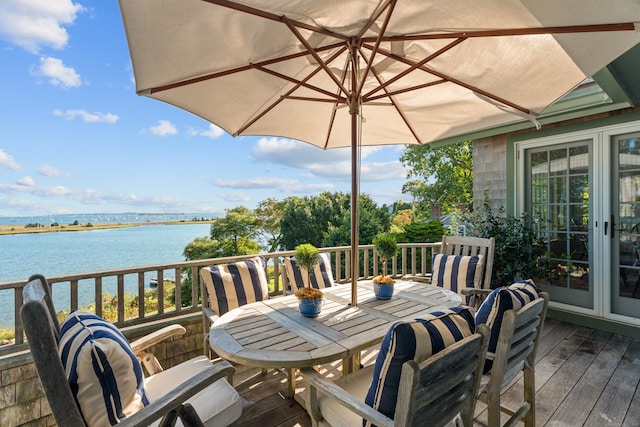 wooden terrace featuring a water view