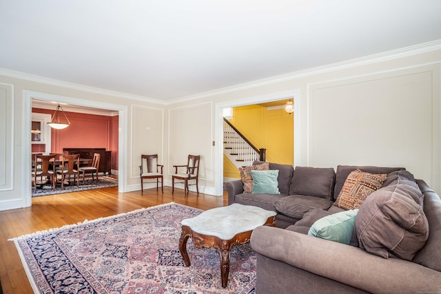 living room with wood-type flooring and crown molding