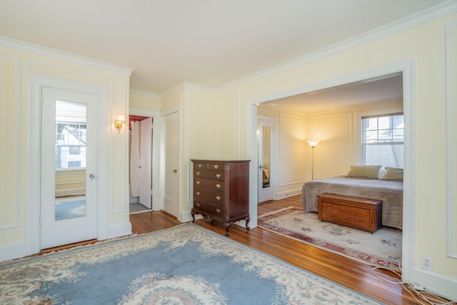 unfurnished bedroom with hardwood / wood-style floors and ornamental molding