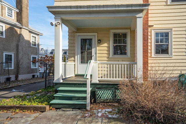 view of exterior entry featuring a porch